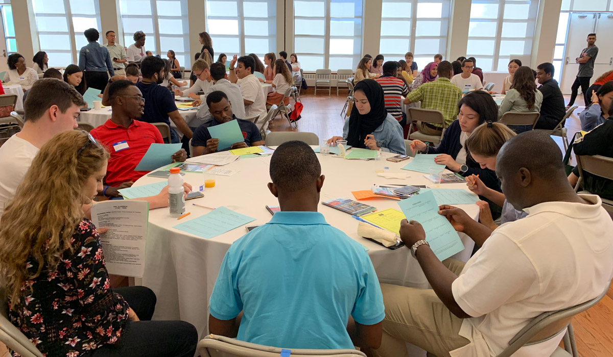 table of international students filling out paperwork