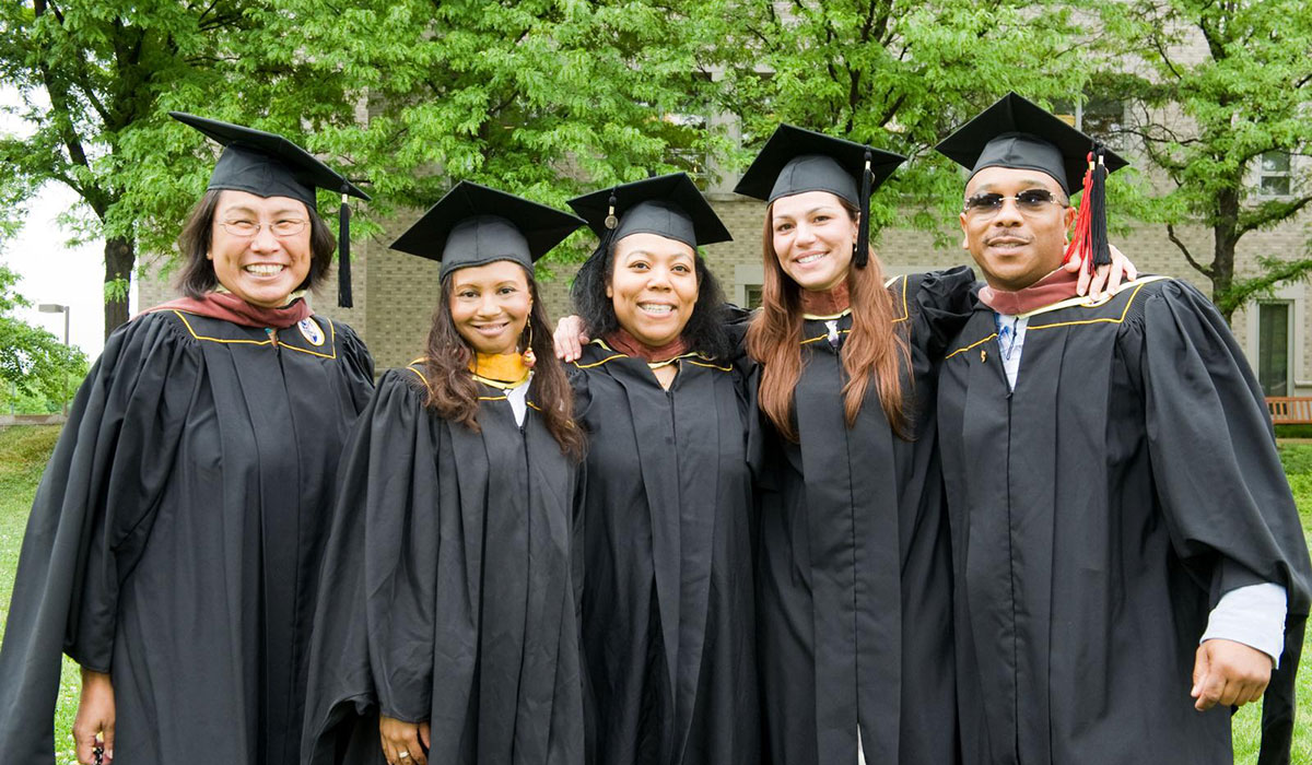 graduates side-by-side smiling