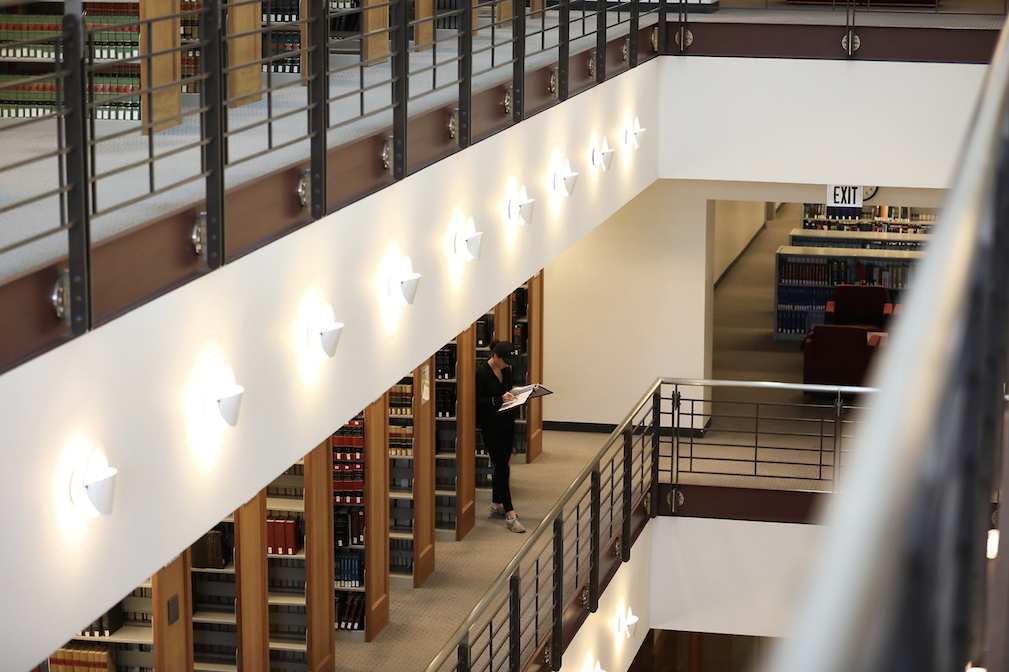 stack of books on two levels, in a library