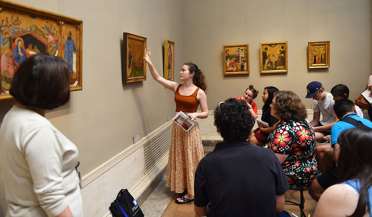 class in a museum looking at a painting