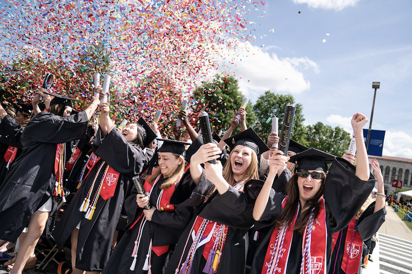 may 2024 graduates shooting confetti in the sky as a celebration