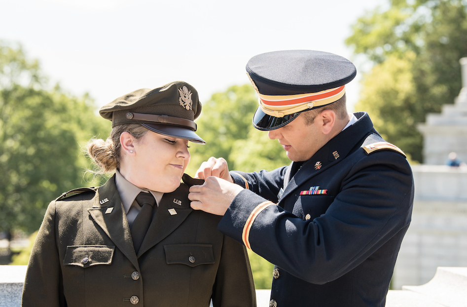 Female military personnel being pinned