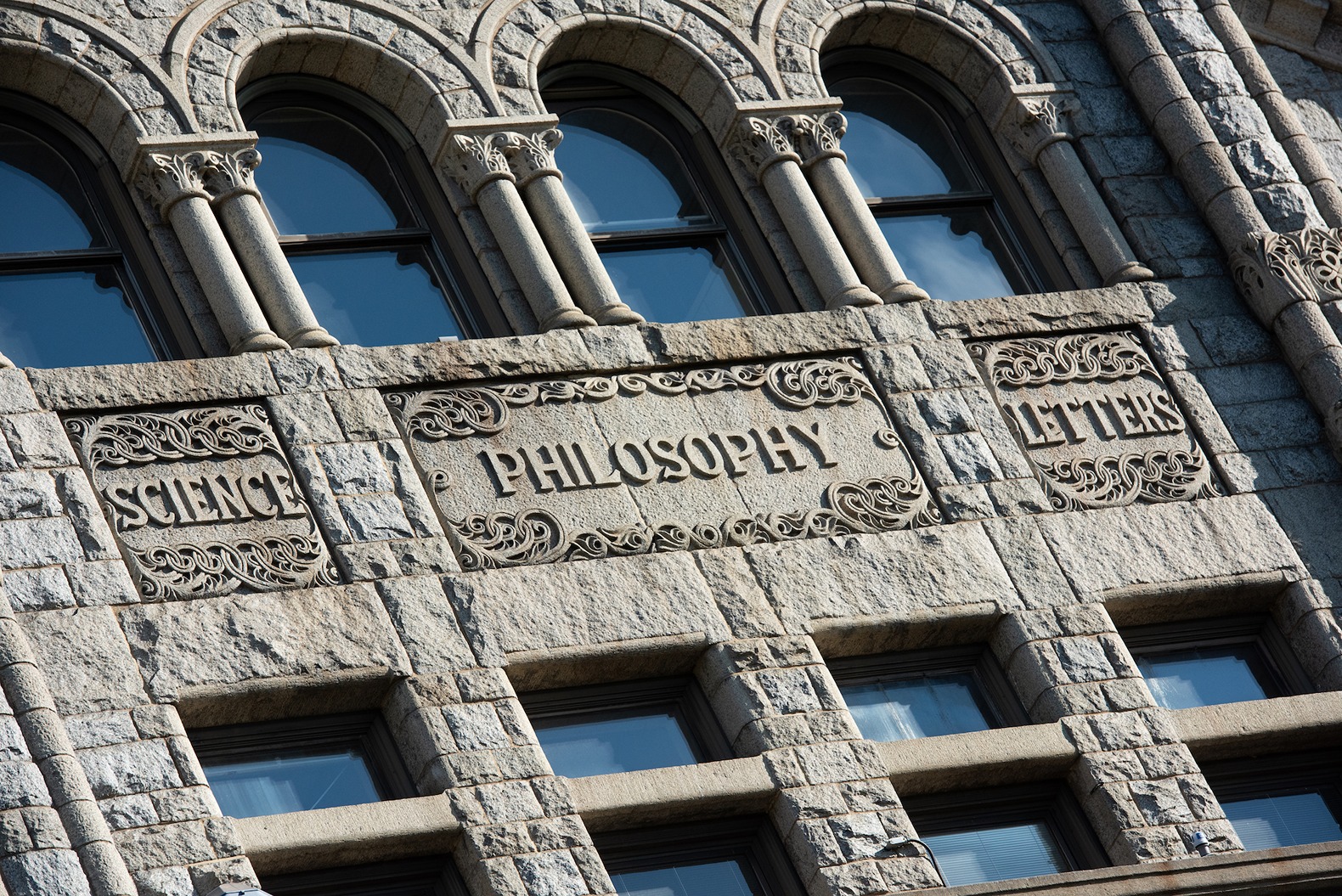 exterior of a building that has the word "philosophy" engnraved into it