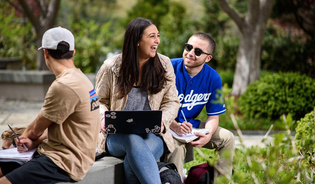 girl and boy conversing and laughing outside