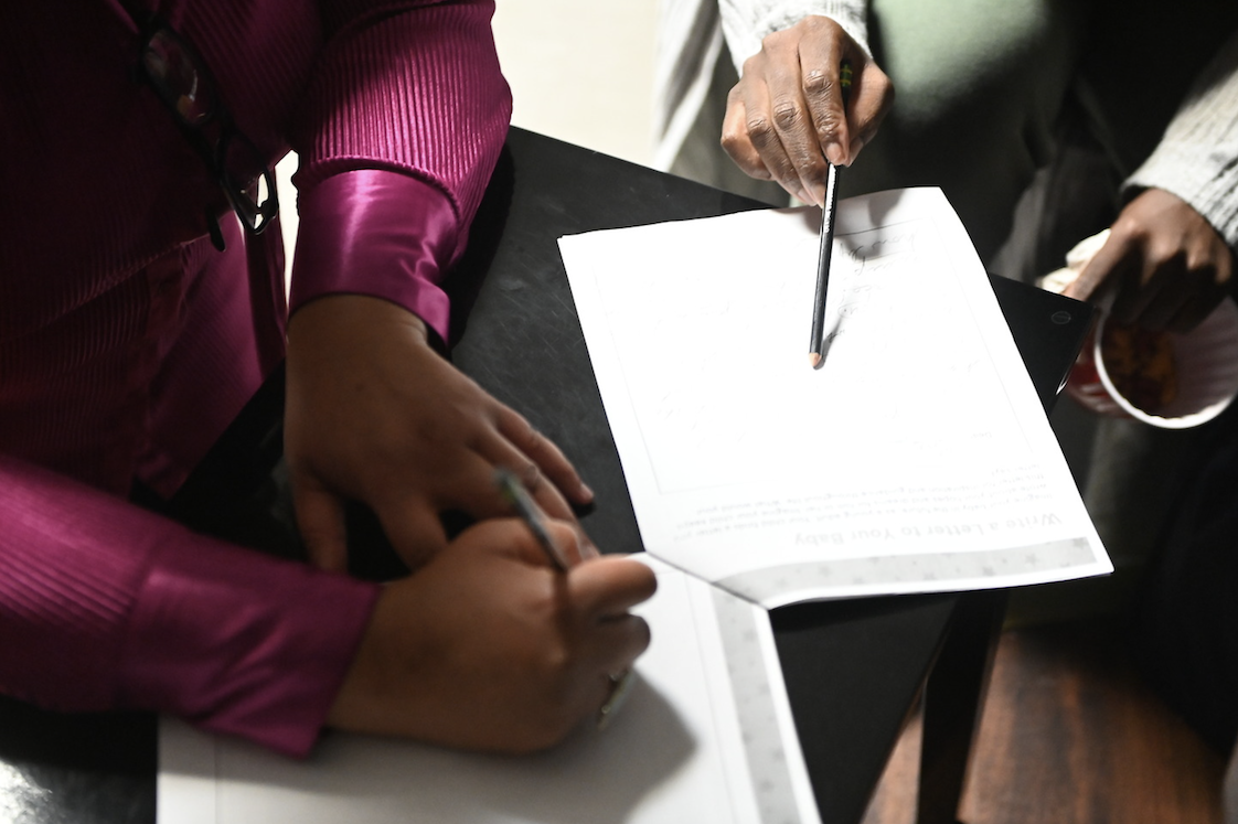 person signing a paper