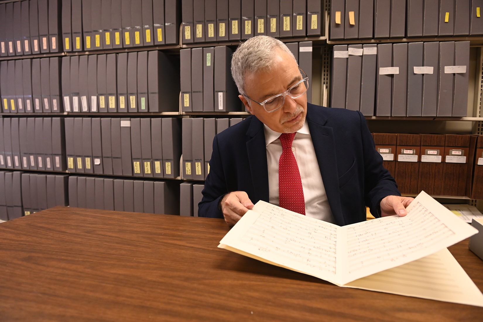  LAMC Director Gustavo Ahualli reviews a manuscript from the library’s extensive collection. (Catholic University/Patrick G. Ryan)