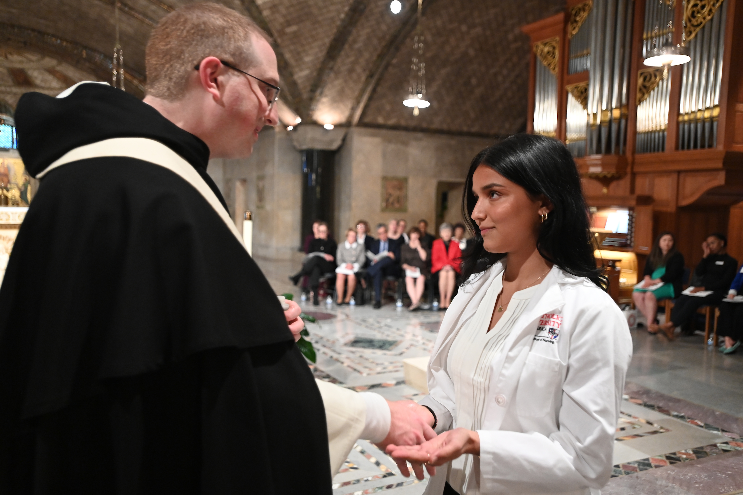 Juniors from the Conway School of Nursing take part in Blessing of Hands ceremony at the National Shrine of the Immaculate Conception. Image by Patrick G. Ryan, University Photographer. 