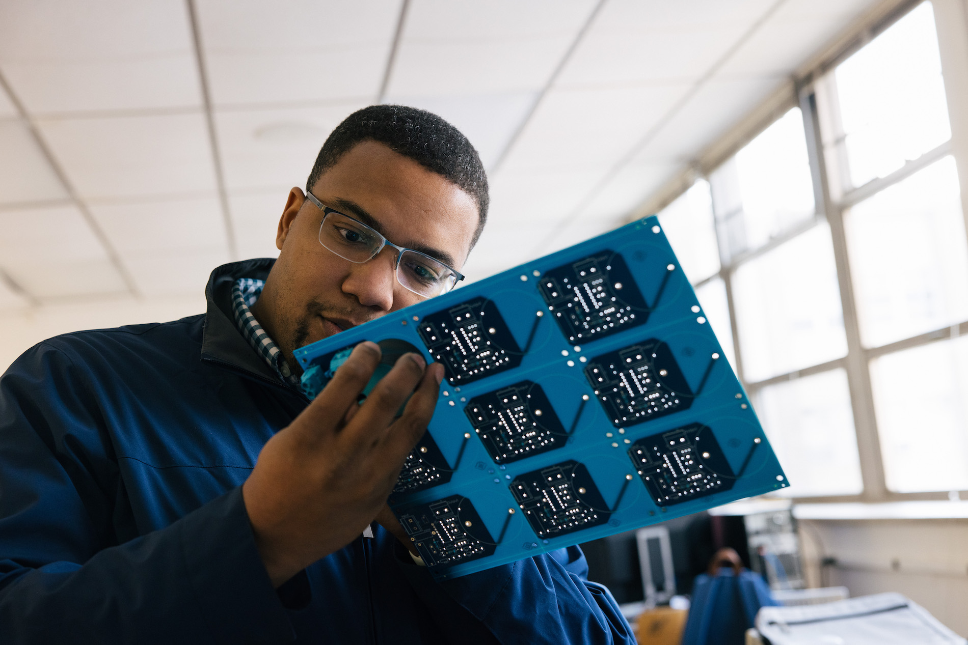 student working on a computer part 