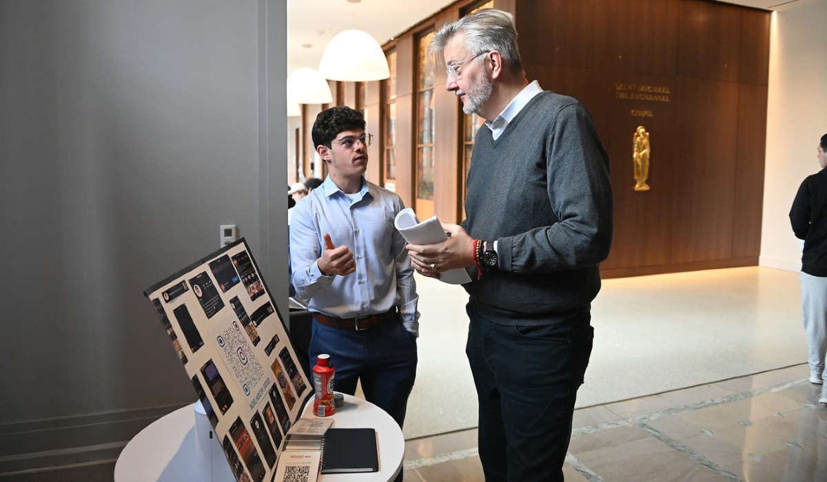 Business School professor and student are talking.