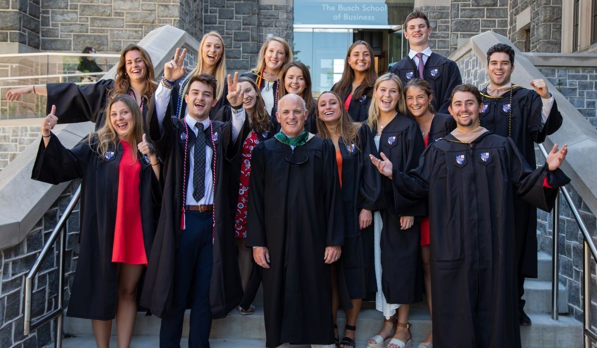 Sales graduates standing outside the Business School.