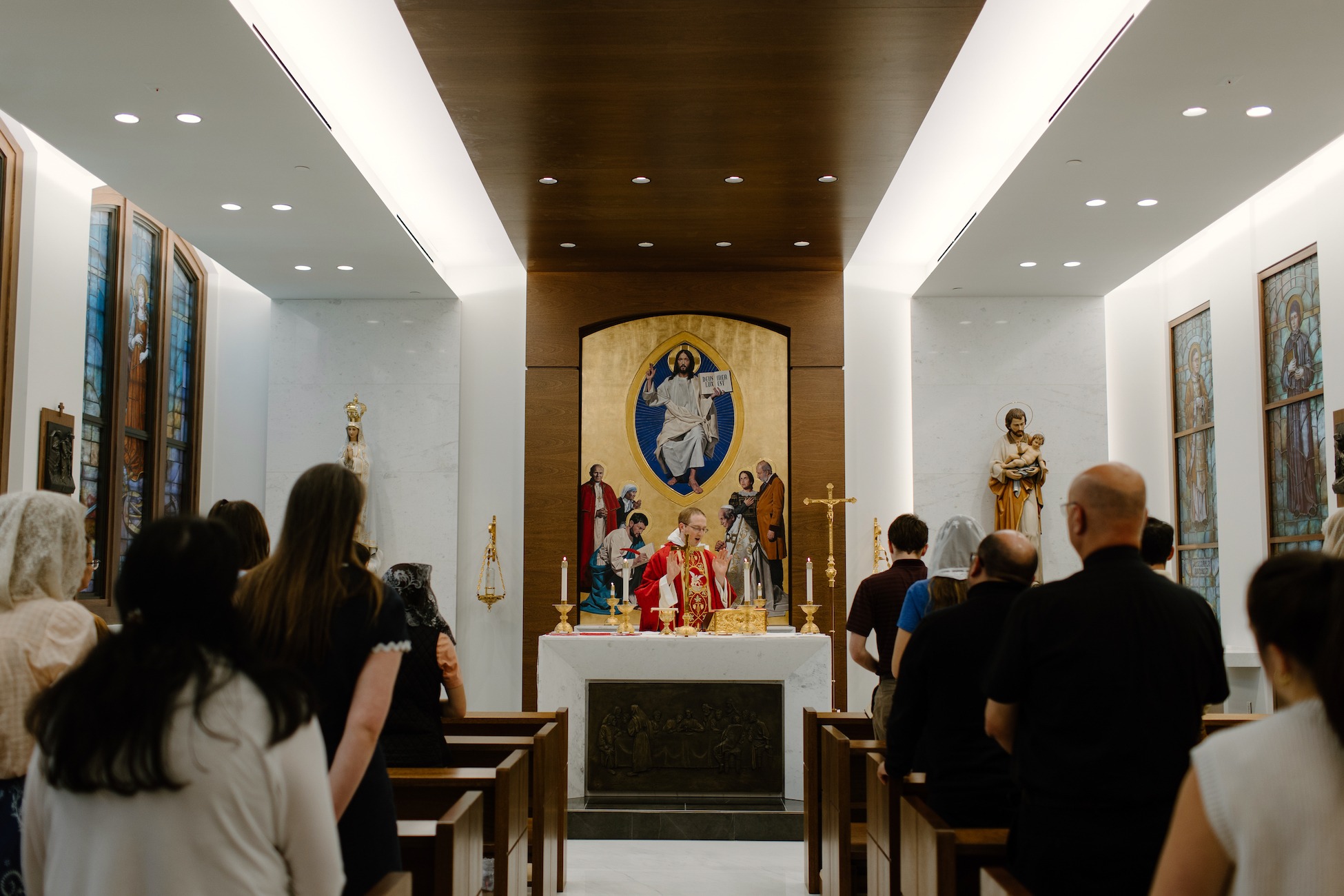 mass being celebrated inside the St. Michael chapel on campus