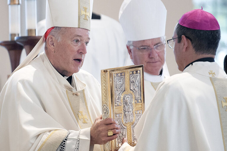   Cardinal Robert W. McElroy of San Diego presents the Book of Gospels to Auxiliary Bishop Felipe Pulido during his episcopal ordination Mass at St. Therese of Carmel Church in San Diego Sep. 28, 2023. 