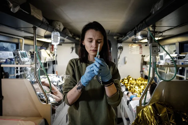 lena Gerasymyuk, a Ukrainian poet and volunteer paramedic with the Hospitallers medical battalion, works in a medical evacuation bus in the Donetsk region of Ukraine, on Feb. 11, 2023. 