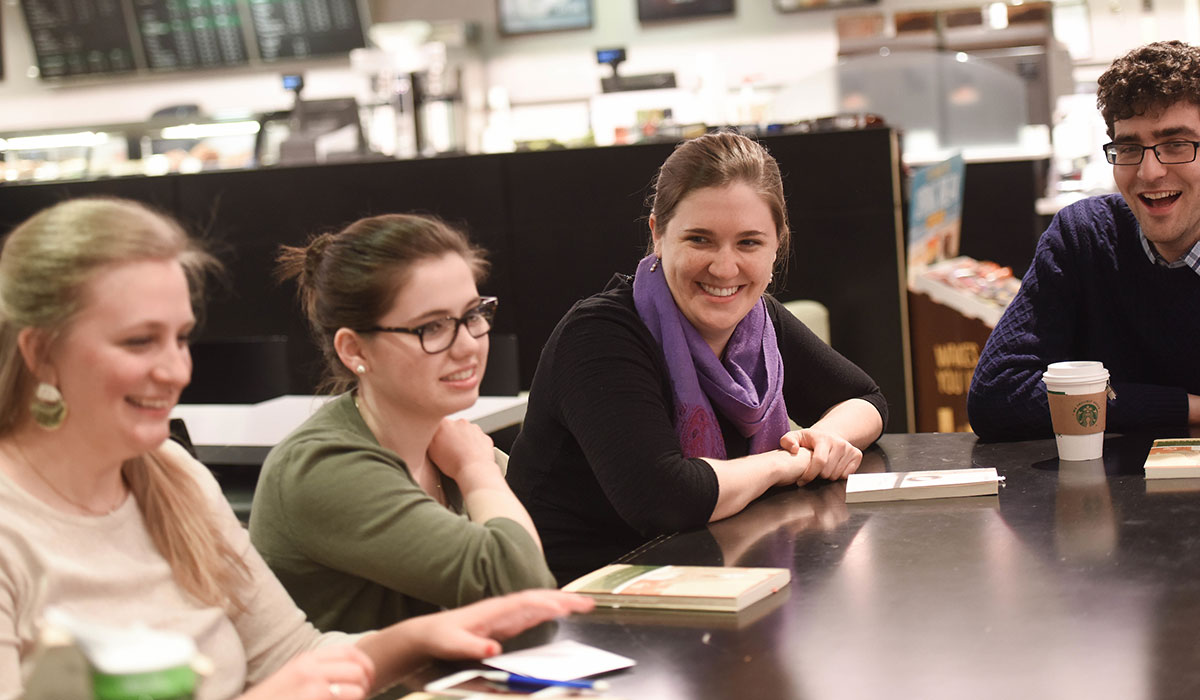 smiling students gathered at a table