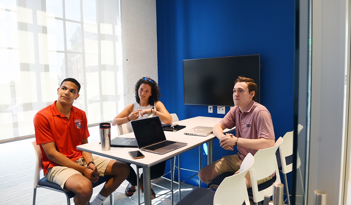 Students sitting a table staring at something off camera