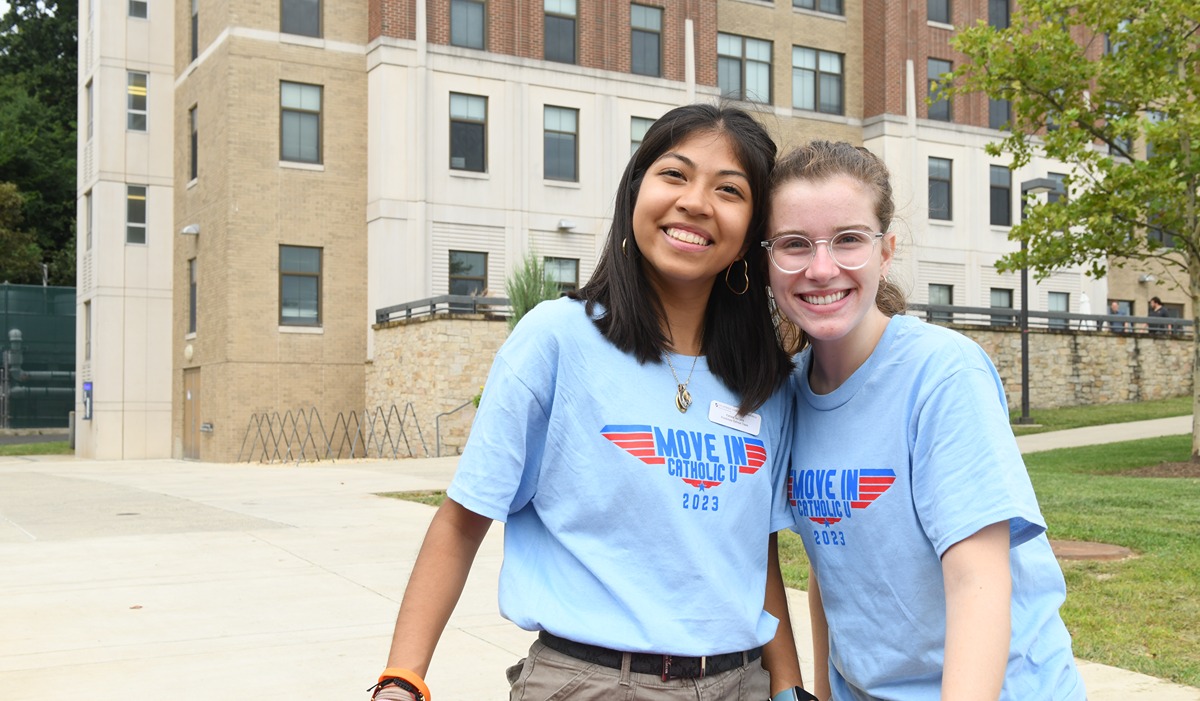 Two student volunteers smiling together