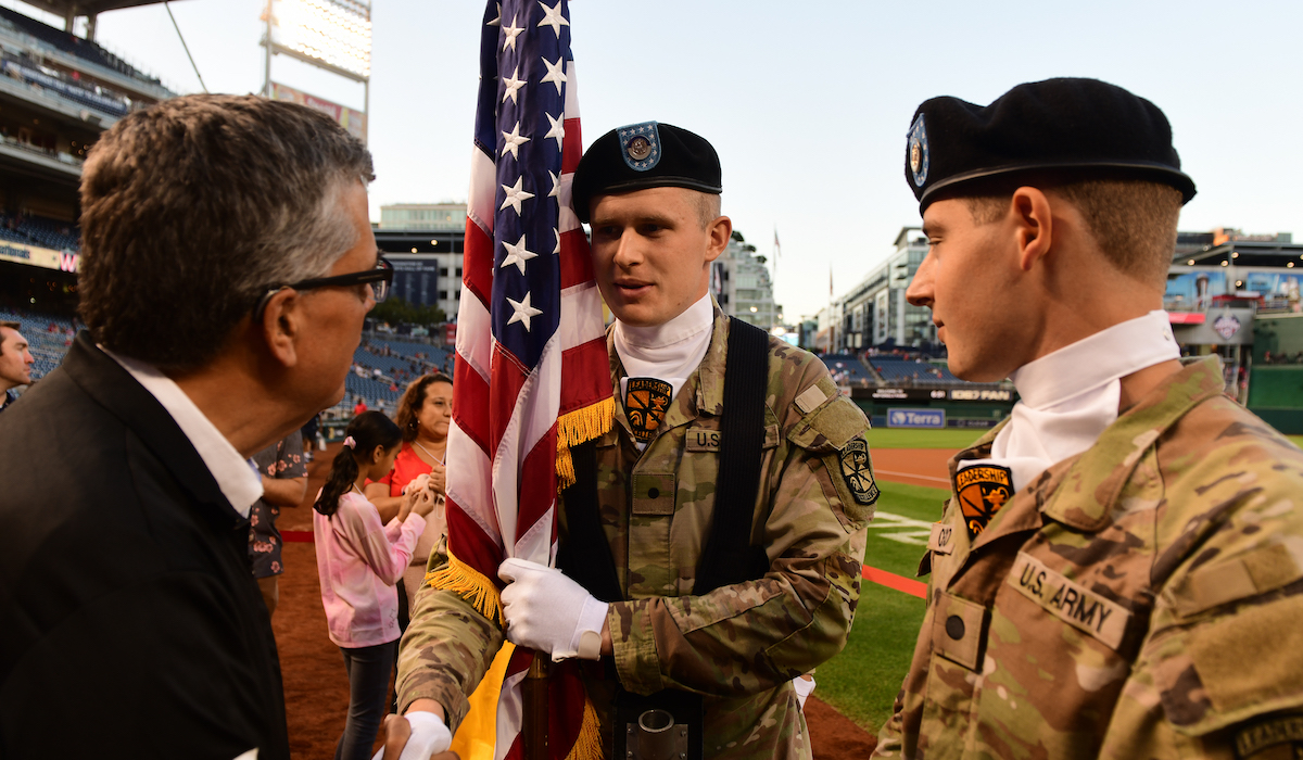 University President Peter K. Kilpatrick greets members of the ROTC on the field at Nationals Park