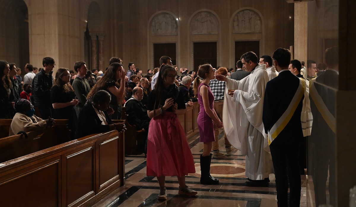 Student receives the eucharist