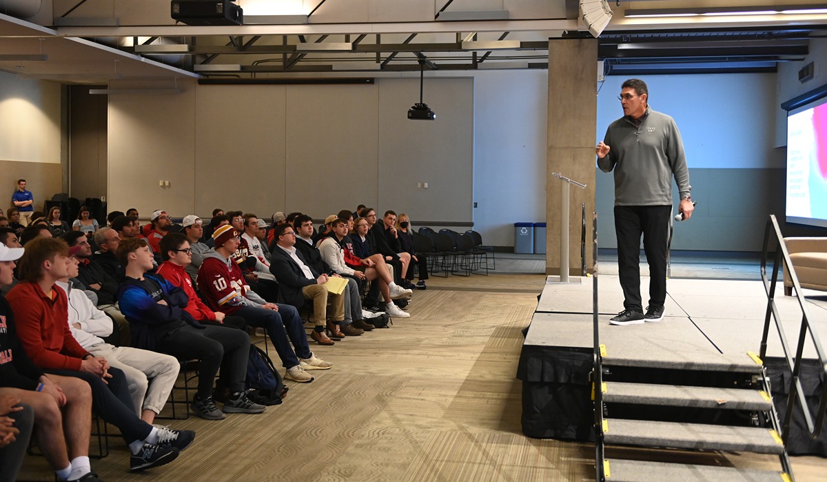 Commanders coach Ron Rivera addresses the Catholic University on stage