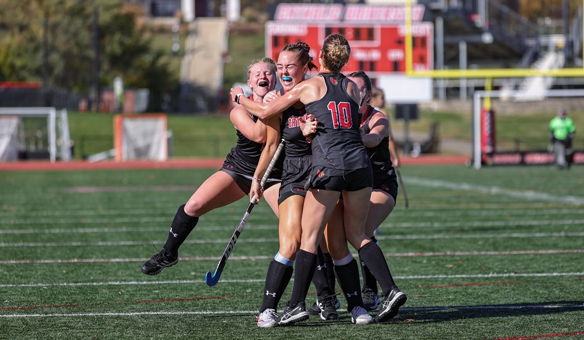 Field hockey team members embrace celebrating 