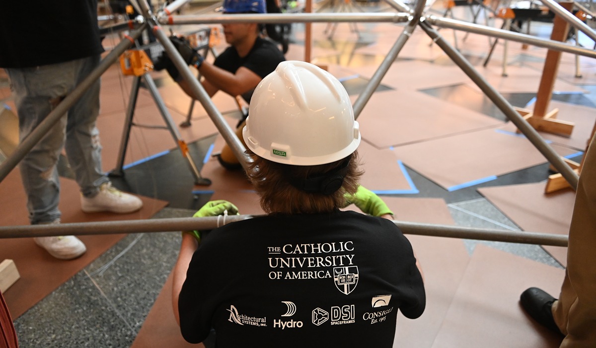 Student working on the dome in a hardhat