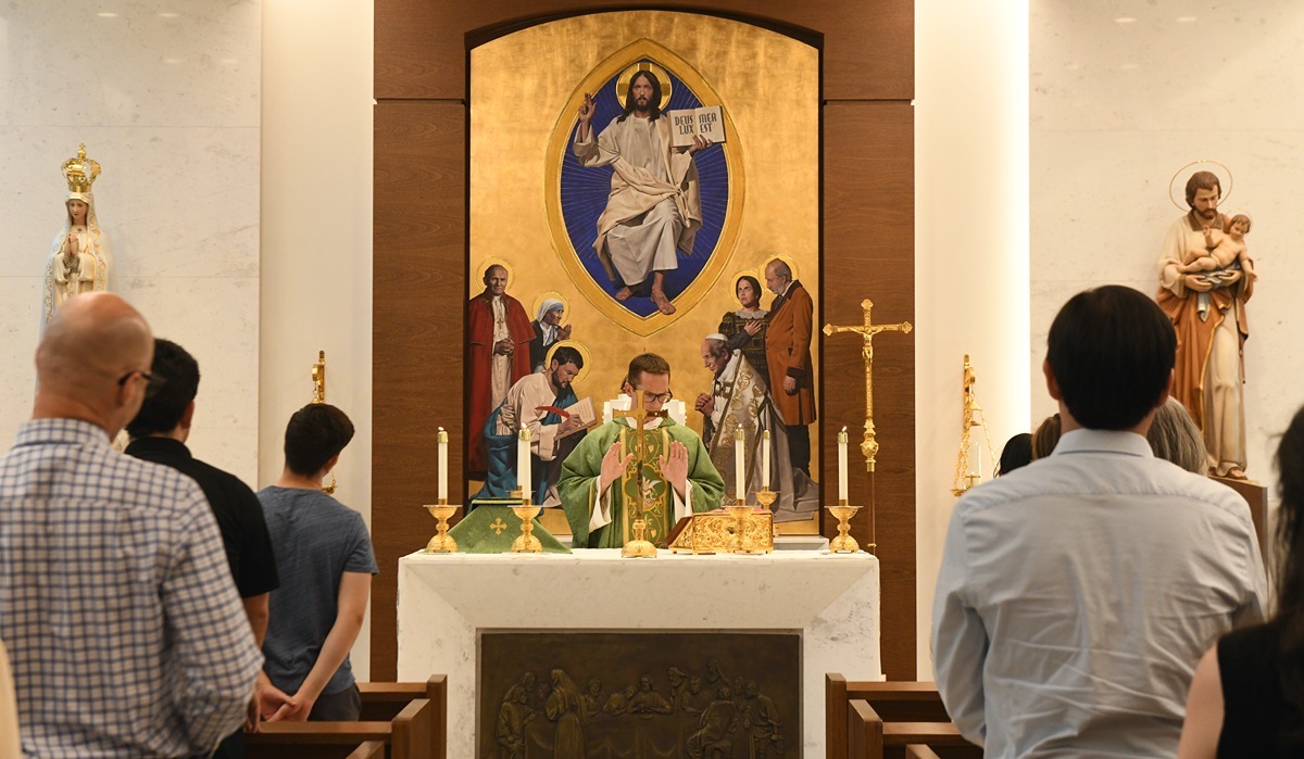 A priest stands before the congregation