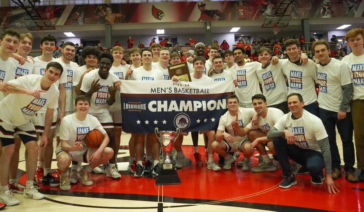 Men's basketball team with their landmark conference banner