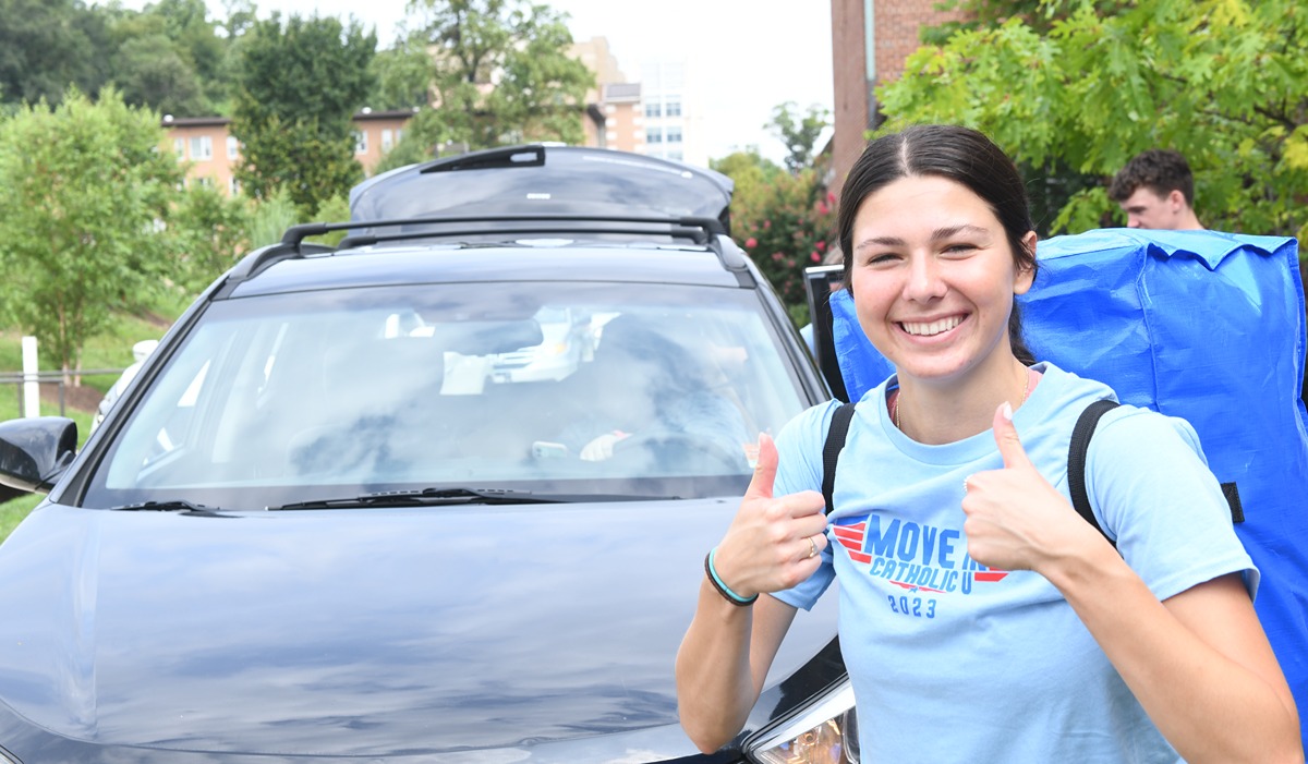 Student smiling with two thumbs up