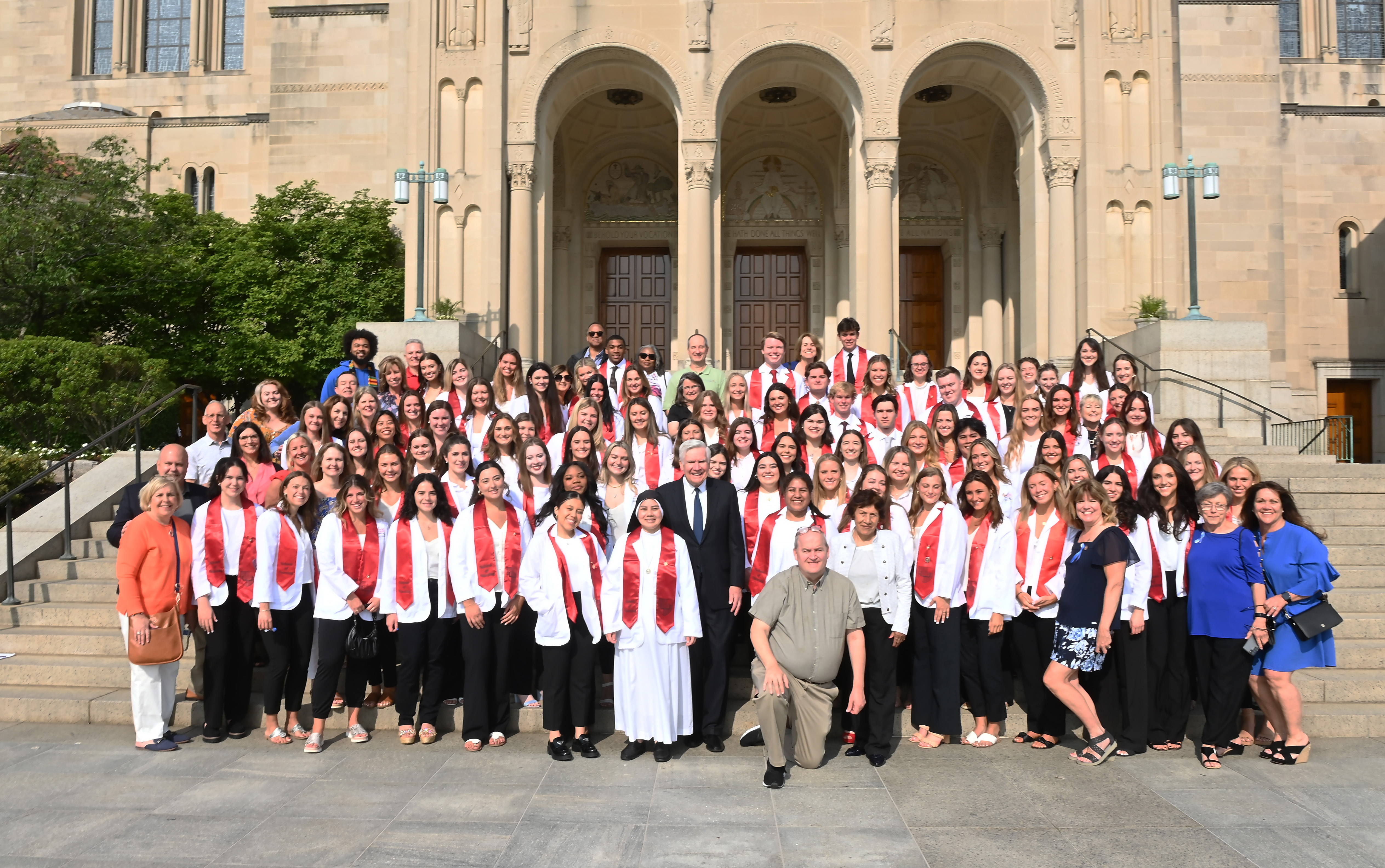 The nursing graduates and faculty assemble on the steps of the Basilica of the National Shrine of the Immaculate Conception before the nursing pinning ceremony