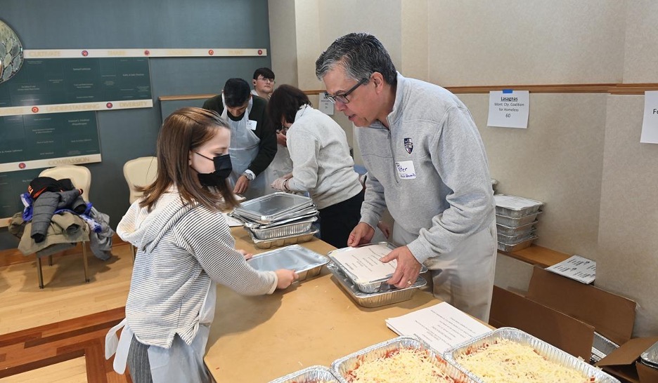 President Kilpatrick assisting with meal packaging for a service event