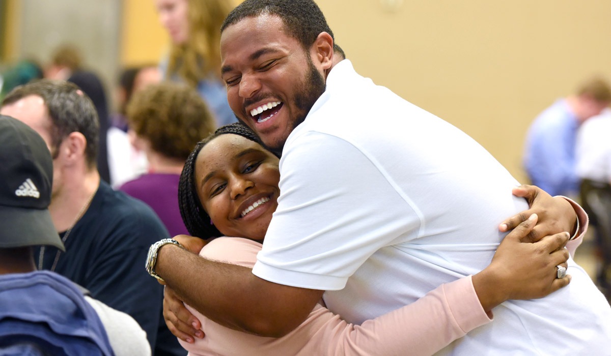 Two people embracing and smiling