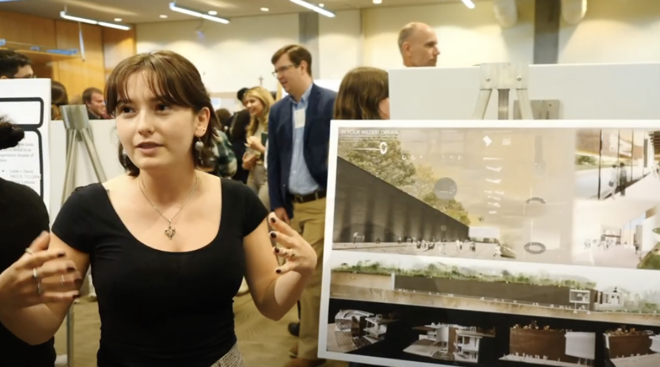 female student presenting her poster