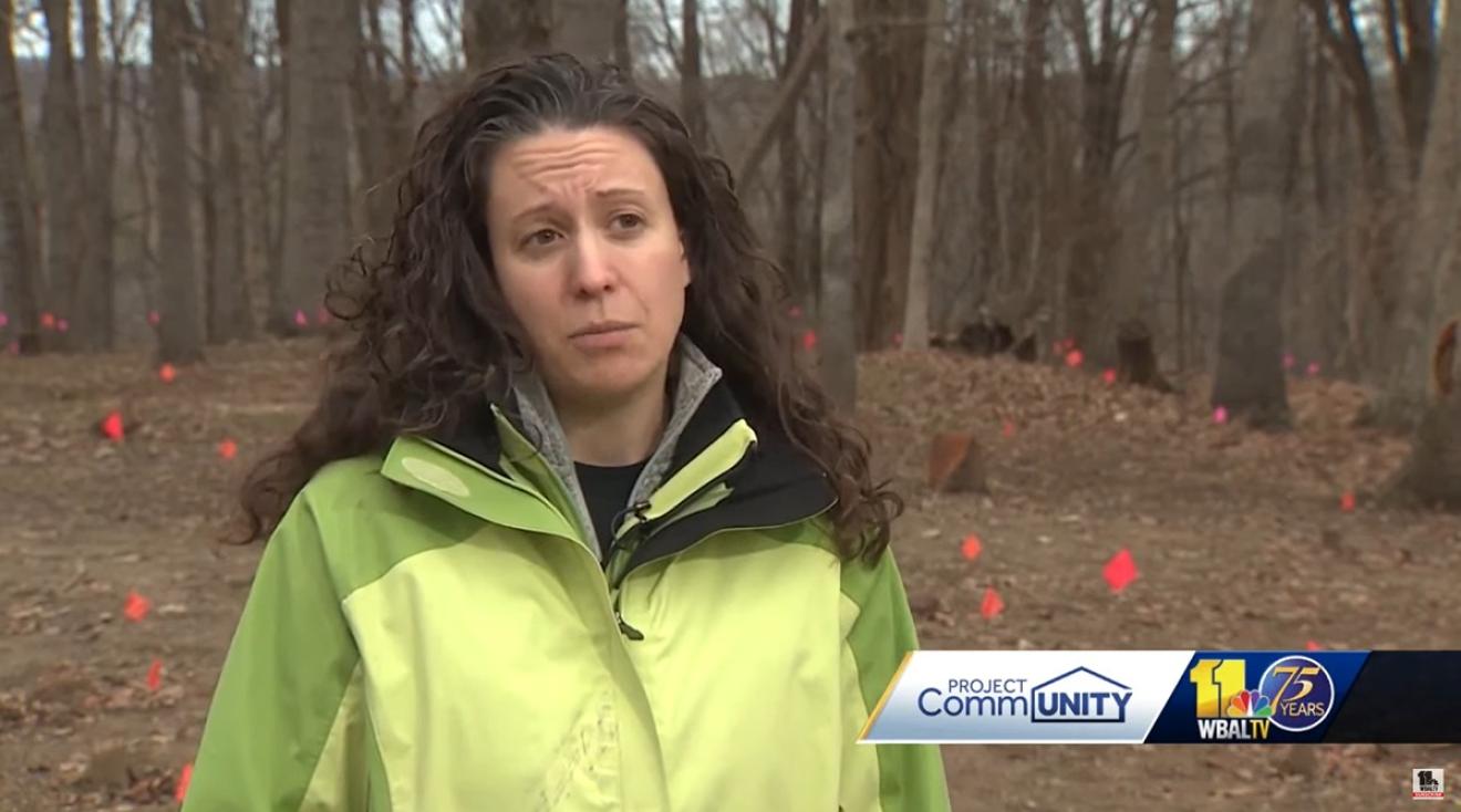 Person in a green jacket interviewed on camera