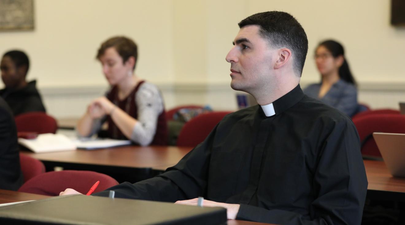 canon law student and seminarian paying attention in class