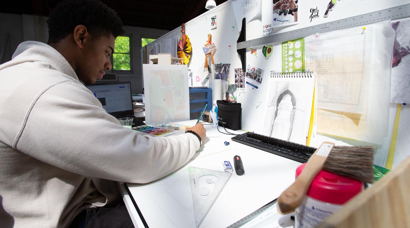 Architecture student working at a desk.